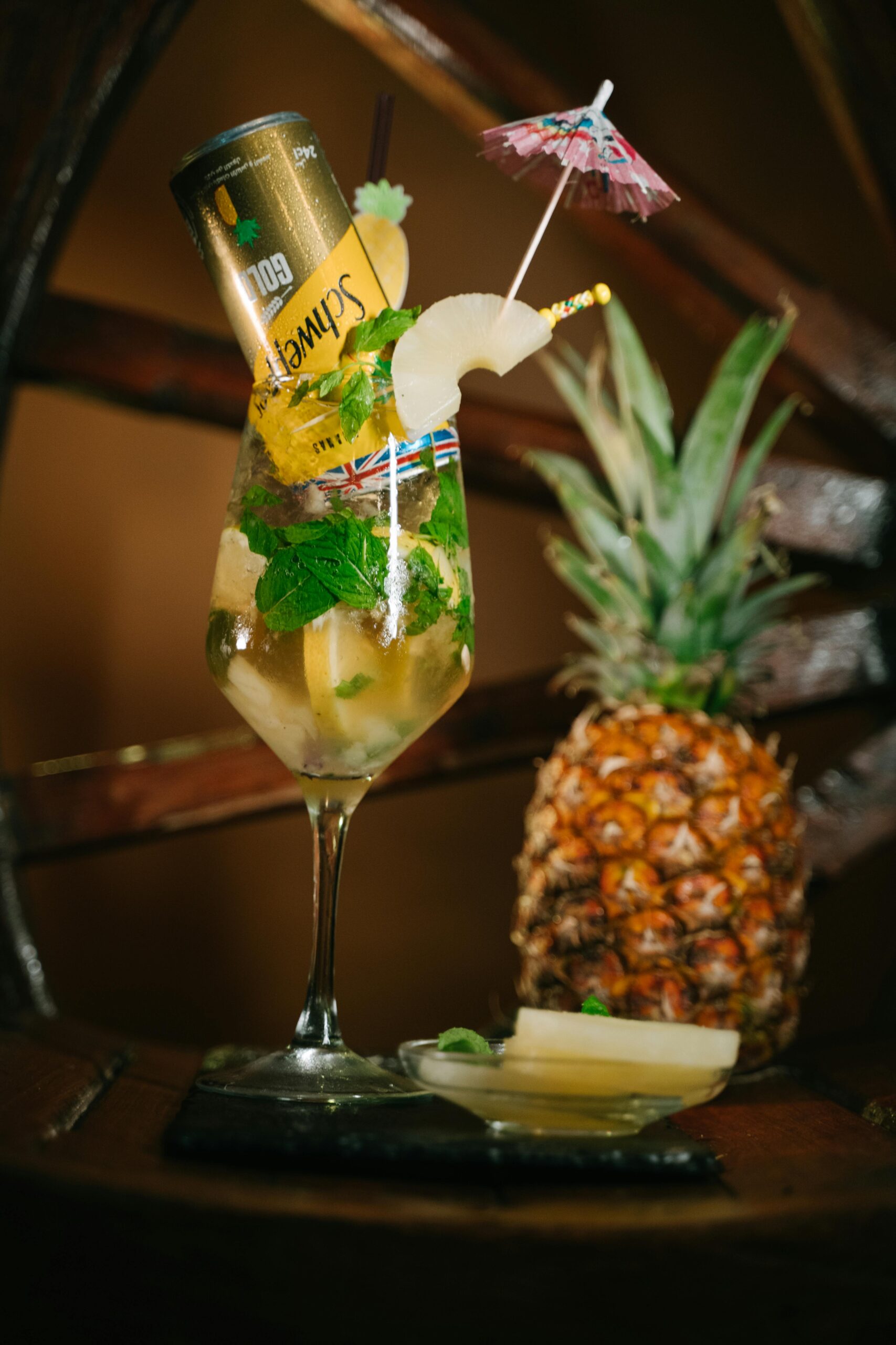 Colorful pineapple cocktail with a can topper and umbrella in Algerian ambiance.